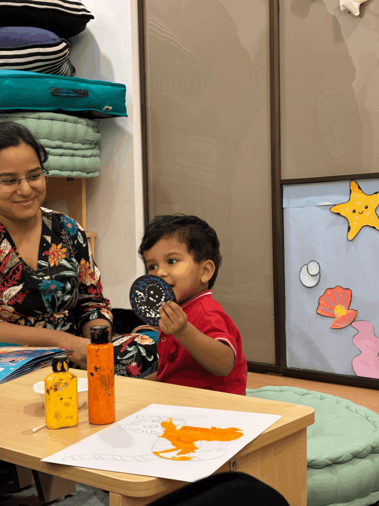 Child exploring mirror play and colors during AI-based brain stimulation activity at ThinkRight